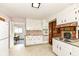 Well-lit kitchen with ample storage, white cabinetry, vintage oven, and convenient access to dining room at 80 S Richland Ave, Carmel, IN 46032