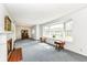 Bright living room with a fireplace, large window, and classic furnishings at 80 S Richland Ave, Carmel, IN 46032