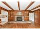 Open living room featuring hardwood floors, wood beams, a fireplace and unique built-in shelving at 80 S Richland Ave, Carmel, IN 46032