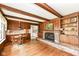 Inviting living room with wood beams, a brick fireplace and a classic built-in bookcase at 80 S Richland Ave, Carmel, IN 46032