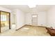 Bright living room with tan carpet, paneled walls, and an ornate front door at 80 S Richland Ave, Carmel, IN 46032