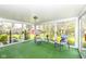 Bright sunroom with comfortable seating and floor-to-ceiling windows showcasing backyard views at 80 S Richland Ave, Carmel, IN 46032