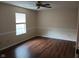 Bedroom with a ceiling fan, wood flooring, and a window providing ample natural light at 8106 Captain Dr, Avon, IN 46123