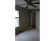 Bedroom with carpet, ceiling fan, and window looking out at trees; also shown, sliding door closet at 8106 Captain Dr, Avon, IN 46123