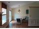 Inviting dining area featuring a vaulted ceiling, stylish chandelier, and convenient access to the kitchen at 8106 Captain Dr, Avon, IN 46123