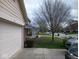 View of a home's driveway and street, highlighting mature trees and the residential neighborhood at 8106 Captain Dr, Avon, IN 46123