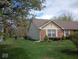 Well-maintained brick and vinyl home with a manicured lawn and trimmed bushes and brick accent at 8106 Captain Dr, Avon, IN 46123