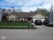 Inviting one-story home with a well-kept lawn, charming landscaping, and two-car driveway at 8106 Captain Dr, Avon, IN 46123