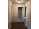Hallway featuring paneled walls, wood floors, and an abundance of closet space at 8106 Captain Dr, Avon, IN 46123