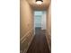 Well-lit hallway with wood floors and wainscoting, showcasing a glimpse into the living area at 8106 Captain Dr, Avon, IN 46123