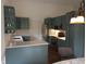 Stylish kitchen featuring trendy teal cabinetry, stainless steel appliances, and sleek countertops at 8106 Captain Dr, Avon, IN 46123