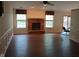 Spacious living room with a brick fireplace, hardwood floors, and natural light from large windows at 8106 Captain Dr, Avon, IN 46123
