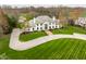 Aerial view of the estate showcasing the expansive driveway, manicured lawn, and elegant home design at 8155 Hunt Club Rd, Zionsville, IN 46077