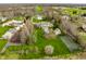 Stunning aerial view highlighting tennis court, large yard and outdoor entertainment areas at 8155 Hunt Club Rd, Zionsville, IN 46077