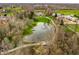 Beautiful home features a serene pond with a fountain, surrounded by mature trees and landscaping at 8155 Hunt Club Rd, Zionsville, IN 46077