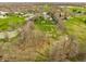 Aerial view displays the luxury home, neighborhood, landscaping, and nearby ponds at 8155 Hunt Club Rd, Zionsville, IN 46077
