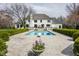 Expansive backyard with a sparkling pool, manicured hedges, and an inviting patio for entertaining at 8155 Hunt Club Rd, Zionsville, IN 46077