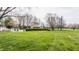 Expansive backyard with a sparkling pool, lush lawn, and mature trees, perfect for outdoor living at 8155 Hunt Club Rd, Zionsville, IN 46077