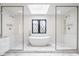 Bright, white bathroom featuring a soaking tub and two glass enclosed showers with modern fixtures at 8155 Hunt Club Rd, Zionsville, IN 46077