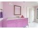 Cute bathroom featuring colorful pink vanity, geometric tile floors and decorative light fixtures at 8155 Hunt Club Rd, Zionsville, IN 46077