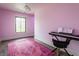 Bedroom with light pink walls, a decorative rug, piano and chair, and dark hardwood flooring at 8155 Hunt Club Rd, Zionsville, IN 46077