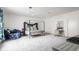 Spacious bedroom with a four poster bed, seating area, and vanity at 8155 Hunt Club Rd, Zionsville, IN 46077