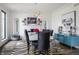 The dining room features a sleek white table, black chairs, modern lighting, and a view of the fireplace and custom details at 8155 Hunt Club Rd, Zionsville, IN 46077