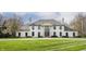 Elegant home with a grand entrance, complete with stately columns and a meticulously maintained lawn and landscaping at 8155 Hunt Club Rd, Zionsville, IN 46077