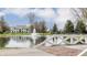 Stunning home featuring a pond, fountain, and a brick pathway with manicured landscaping and architectural charm at 8155 Hunt Club Rd, Zionsville, IN 46077