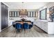 Well-appointed kitchen showcases white countertops, stainless steel appliances, and elegant breakfast area with designer lighting at 8155 Hunt Club Rd, Zionsville, IN 46077