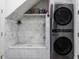 Convenient laundry room with dog washing station and stacked washer/dryer at 8155 Hunt Club Rd, Zionsville, IN 46077