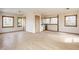 Bright, open living room featuring hardwood floors and natural light from large, wooden-trimmed windows at 8155 Hunt Club Rd, Zionsville, IN 46077