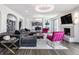 Open-concept living room featuring modern finishes, fireplace, and access to a chef-inspired kitchen and dining area at 8155 Hunt Club Rd, Zionsville, IN 46077