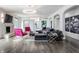 Stylish living room featuring modern decor, hardwood floors, statement lighting, and an open, airy layout at 8155 Hunt Club Rd, Zionsville, IN 46077