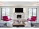 Inviting living room with fireplace, unique decor, hardwood floors, and a comfortable and stylish seating arrangement at 8155 Hunt Club Rd, Zionsville, IN 46077