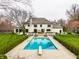 Inviting in-ground pool with a diving board, surrounded by manicured hedges and lush lawn at 8155 Hunt Club Rd, Zionsville, IN 46077