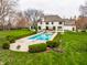 Charming in-ground pool with elegant landscaping and outdoor dining area at 8155 Hunt Club Rd, Zionsville, IN 46077