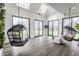 Inviting sunroom with hanging swing chairs and skylights at 8155 Hunt Club Rd, Zionsville, IN 46077