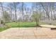 Large backyard features mature trees, lush green grass, and spacious wooden deck at 8715 Kensington Dr, Noblesville, IN 46060