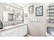 Bright bathroom with double vanity, granite countertop, framed mirror and decorative wall hangings at 8715 Kensington Dr, Noblesville, IN 46060