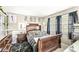 Comfortable bedroom with dark wood furniture, rug, and natural lighting at 8715 Kensington Dr, Noblesville, IN 46060