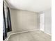 Empty bedroom with neutral walls, carpet, and a large window with dark curtains at 8715 Kensington Dr, Noblesville, IN 46060