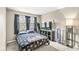 Cozy bedroom with dark blue curtains, TV, a floor lamp, and comfortable bedding at 8715 Kensington Dr, Noblesville, IN 46060