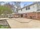 Multi-level deck leads to backyard with mature trees with the brick back of the house shown at 8715 Kensington Dr, Noblesville, IN 46060