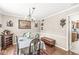 Formal dining room with elegant chandelier, stylish furniture, and hardwood floors at 8715 Kensington Dr, Noblesville, IN 46060