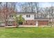 Back of house shows the multi-level deck and brick-and-white-siding facade and a well-kept lawn at 8715 Kensington Dr, Noblesville, IN 46060