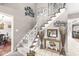 Welcoming foyer with a staircase, tiled flooring, and decorative accents, providing an inviting entrance at 8715 Kensington Dr, Noblesville, IN 46060