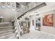 Spacious foyer featuring a staircase with ornate railings and decor, offering a grand entrance to the home at 8715 Kensington Dr, Noblesville, IN 46060