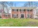 Beautiful two-story brick home with a column-lined porch, black shutters, and a well-maintained front lawn at 8715 Kensington Dr, Noblesville, IN 46060