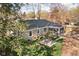Cozy backyard featuring a screened-in porch, stone patio with seating, and mature trees at 928 Forest Blvd N Dr, Indianapolis, IN 46240